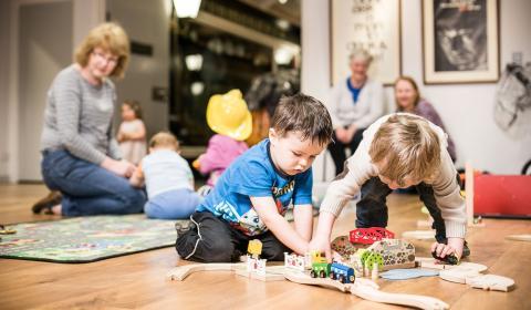 Image of children playing with a wooden train set